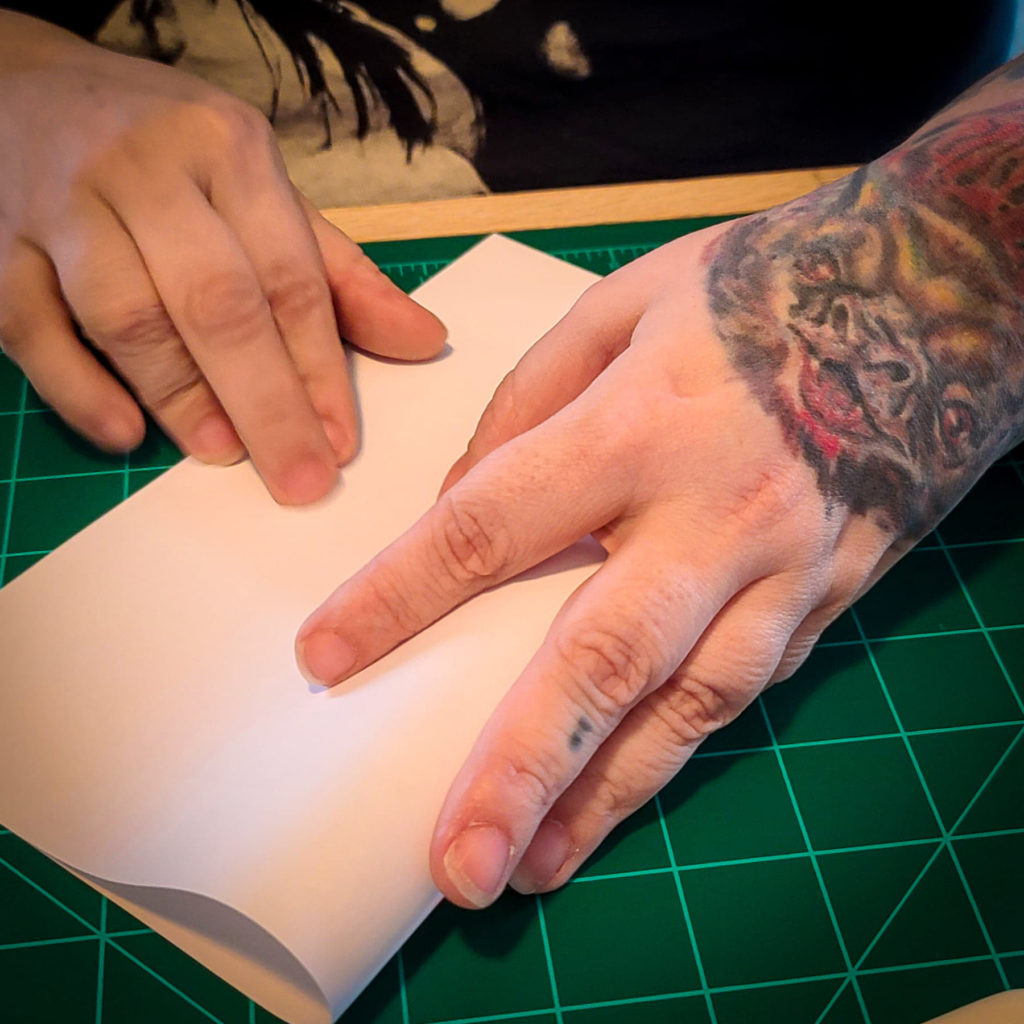 Hands Folding Paper Image